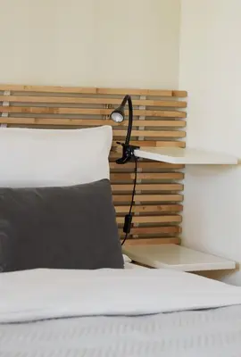 a bedroom with a bed with a lamp on it at Słowackiego Avenue Cozy Stay Studio by BookingHost in Kraków