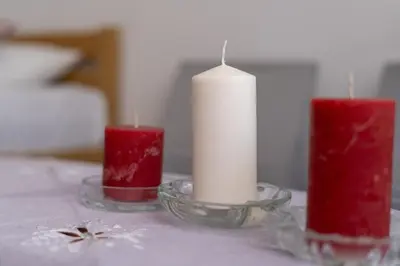 three candles are sitting on a table at Grzegórzki Pleasant Apartment by BookingHost in Kraków
