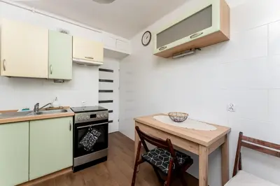 a kitchen with a small table and a sink at Grzegórzki Pleasant Apartment by BookingHost in Kraków