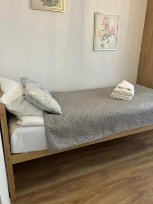 a bed with pillows on it in a room at Grzegórzki Pleasant Apartment by BookingHost in Kraków