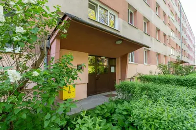a building with a brown door and a balcony at Grzegórzki Pleasant Apartment by BookingHost in Kraków