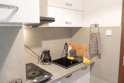 a kitchen with a sink and a counter top at Apartment Azory in Kraków