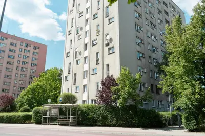 a tall building with a sign in front of it at Apartment Azory in Kraków