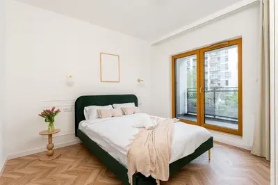 a bedroom with a bed and a window at Malila Premium Apartments Cracow Rakowicka 254 in Kraków