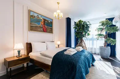 a bedroom with a bed with towels on it at Prestige Central Apartment with Sauna & Parking in Kraków
