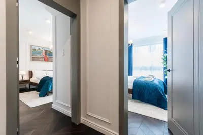 a hallway with a bedroom with a bed at Prestige Central Apartment with Sauna & Parking in Kraków