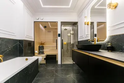 a bathroom with a tub and a sink at Prestige Central Apartment with Sauna & Parking in Kraków