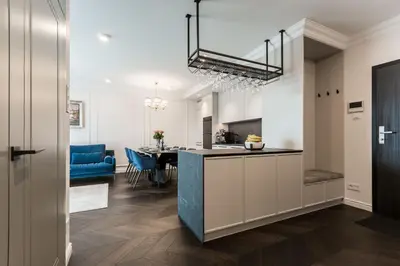 a kitchen and dining room with a blue counter top at Prestige Central Apartment with Sauna & Parking in Kraków