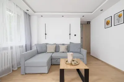 a living room with a couch and a table at Apartment with Balcony - Łobzowska 57 street in Kraków