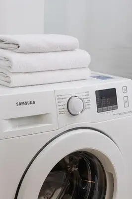 a washing machine with towels on top of it at Apartment with Balcony - Łobzowska 57 street in Kraków