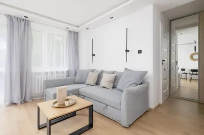 a living room with a couch and a table at Apartment with Balcony - Łobzowska 57 street in Kraków