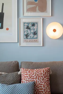 a living room with a couch and pictures on the wall at OSKA Apartment near Expo, Tauron Arena in Kraków