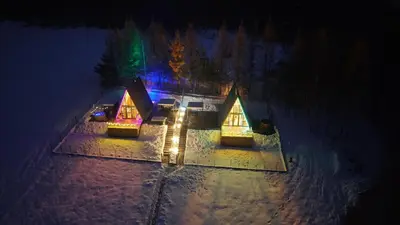 a church lit up in the dark at night at The Sun House in Męcina