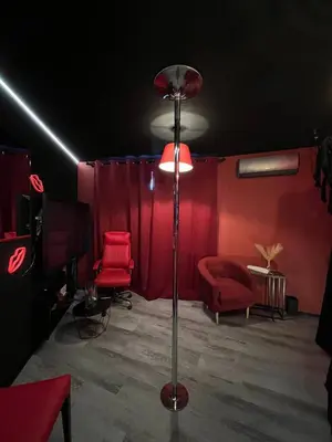 a room with a tv and red chairs and a table at Lust&Desire BDSM Krakow Apartment in Kraków