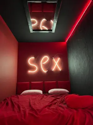 a red bedroom with a bed with a swing at Lust&Desire BDSM Krakow Apartment in Kraków