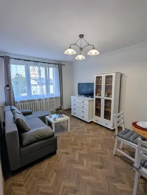 a living room with a couch and a table at Apartament na Kazimierzu in Kraków