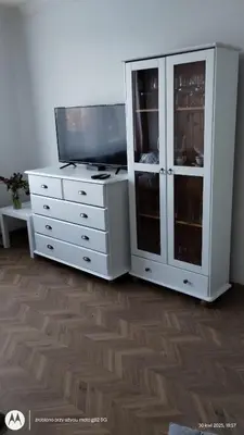 a white dresser with a tv on top of it at Apartament na Kazimierzu in Kraków