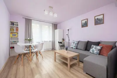 a living room with a couch and a table at Okólna Cozy Apartment Remote Work by Noclegi Renters in Kraków