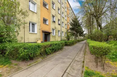 an empty sidewalk in front of a building at Okólna Cozy Apartment Remote Work by Noclegi Renters in Kraków