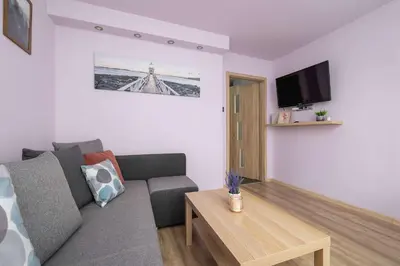 a living room with a couch and a table at Okólna Cozy Apartment Remote Work by Noclegi Renters in Kraków