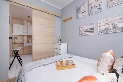 a bedroom with a bed with two shoes on it at Okólna Cozy Apartment Remote Work by Noclegi Renters in Kraków