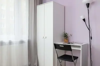 a desk with a chair next to a white cabinet at Okólna Cozy Apartment Remote Work by Noclegi Renters in Kraków