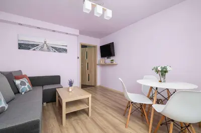 a living room with a couch and a table at Okólna Cozy Apartment Remote Work by Noclegi Renters in Kraków