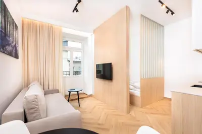 a living room with a white couch and a television at City of the Kings - Riverside K22 M13&28 in Kraków