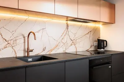 a kitchen with a sink and a marble counter top at City of the Kings - Riverside K22 M13&28 in Kraków