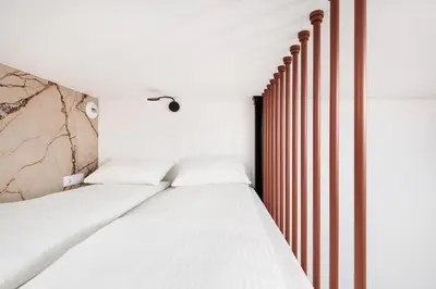 a bedroom with two beds and a wall at City of the Kings - Riverside K22 M13&28 in Kraków