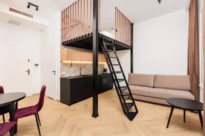 a loft apartment with a spiral staircase in a living room at City of the Kings - Riverside K22 M13&28 in Kraków