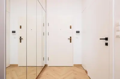 a row of white lockers in a room at City of the Kings - Riverside K22 M13&28 in Kraków
