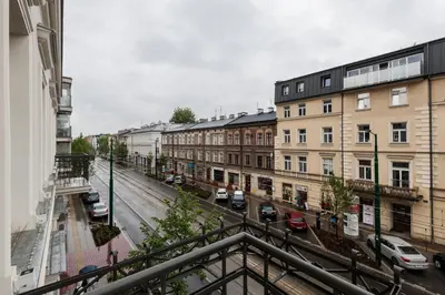 a view of a city street with buildings and cars at City of the Kings - Riverside K22 M13&28 in Kraków