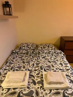 a bed with two pillows on it in a bedroom at Krakowskie Malediwy in Kraków