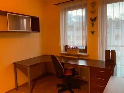 an office with a desk and a chair and window at Krakowskie Malediwy in Kraków