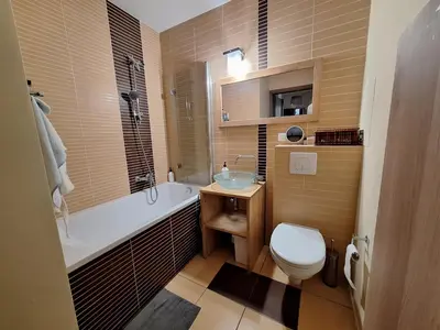 a bathroom with a toilet and a tub and a sink at Krakowskie Malediwy in Kraków