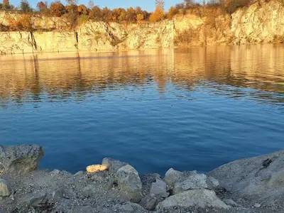 a large body of water with rocks in the foreground at Krakowskie Malediwy in Kraków