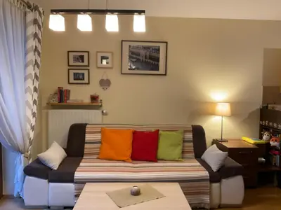 a living room with a couch with colorful pillows at Krakowskie Malediwy in Kraków