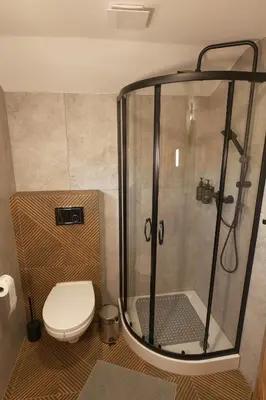 a bathroom with a shower and a toilet at Magiczny Widok Tiny House in Jurków