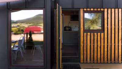 a door to a house with a view of a kitchen at Magiczny Widok Tiny House in Jurków