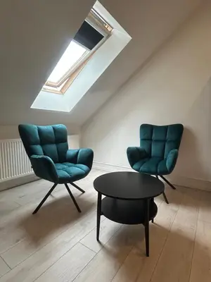 two green chairs and a table in a room at Villa Kraków 2 in Kraków