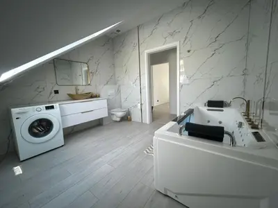 a white bathroom with a washing machine and a sink at Villa Kraków 2 in Kraków
