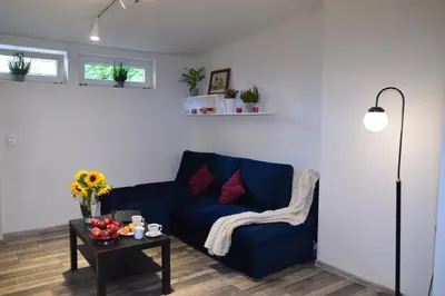 a living room with a blue couch and a table at KING JAGIELLO Apartment in Kraków