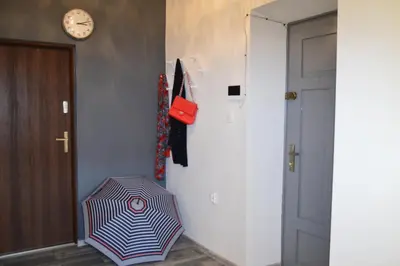 a hallway with an umbrella sitting next to a door at KING JAGIELLO Apartment in Kraków