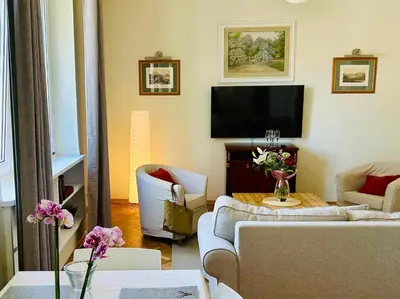 a living room with two couches and a flat screen tv at Dom Parkowy in Kraków
