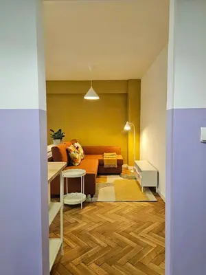 a living room with a couch and a table at Lovely Sparkly Apartment in Kraków
