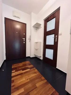 a room with a door and a wooden floor at Central Apart Railway Station in Kraków
