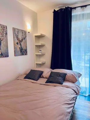 a bed with two pillows in a bedroom with a window at Central Apart Railway Station in Kraków