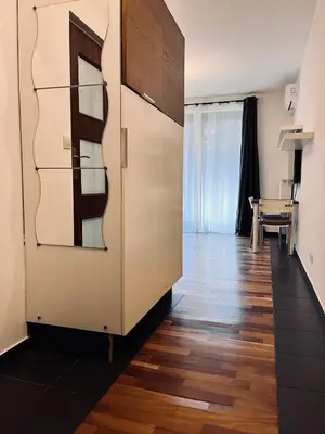 a large cabinet in a room with a table at Central Apart Railway Station in Kraków