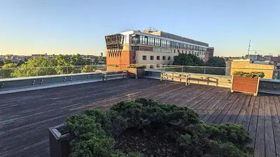 a balcony with two benches on a building at Kaszmir Sky Apartment by Vistula River in Kraków